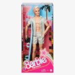 Barbie Movie: Ken Wearing Pastel Striped Beach Set (HPJ97)